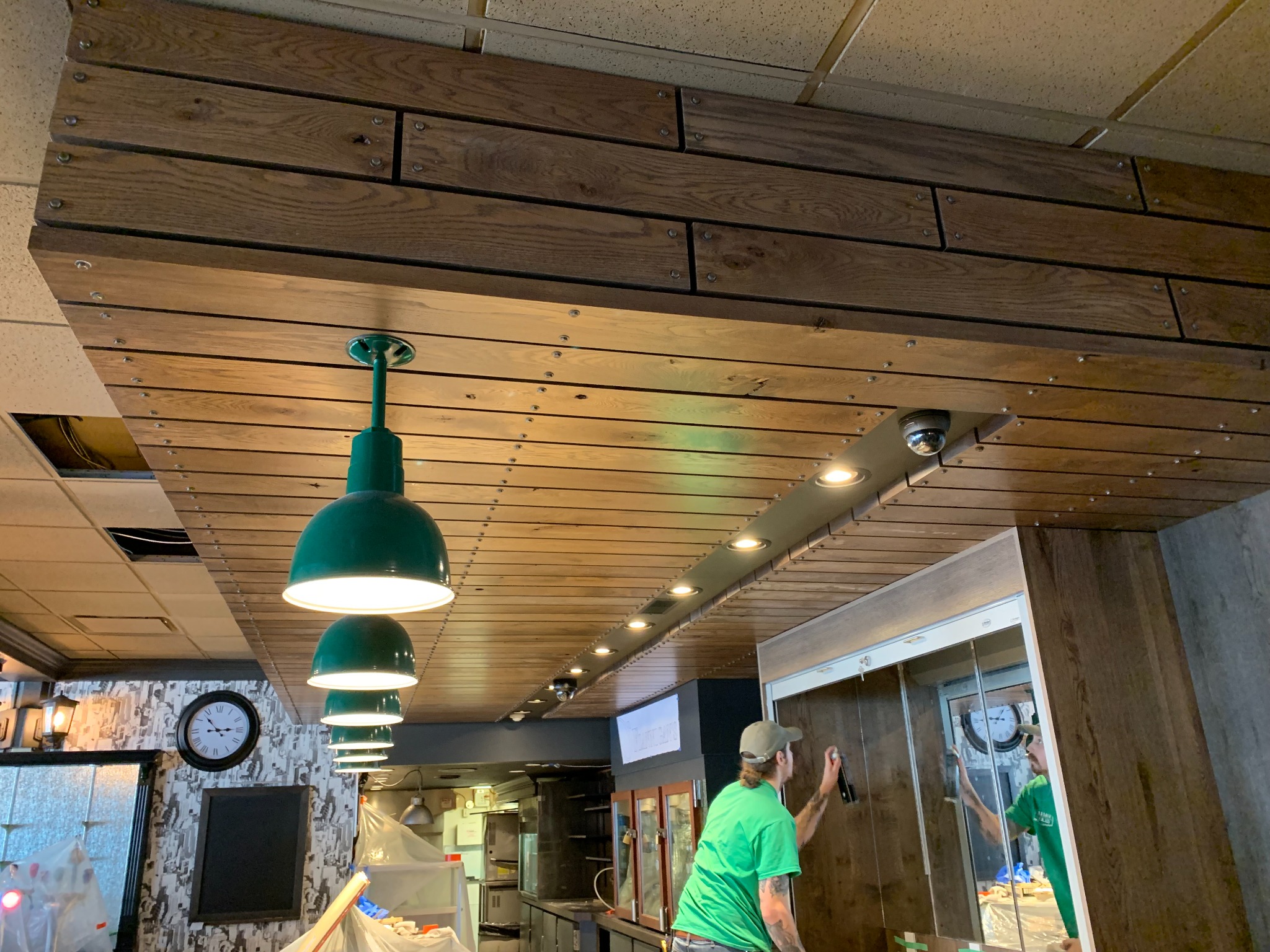 Commercial wood-slat ceiling installation with integrated lighting